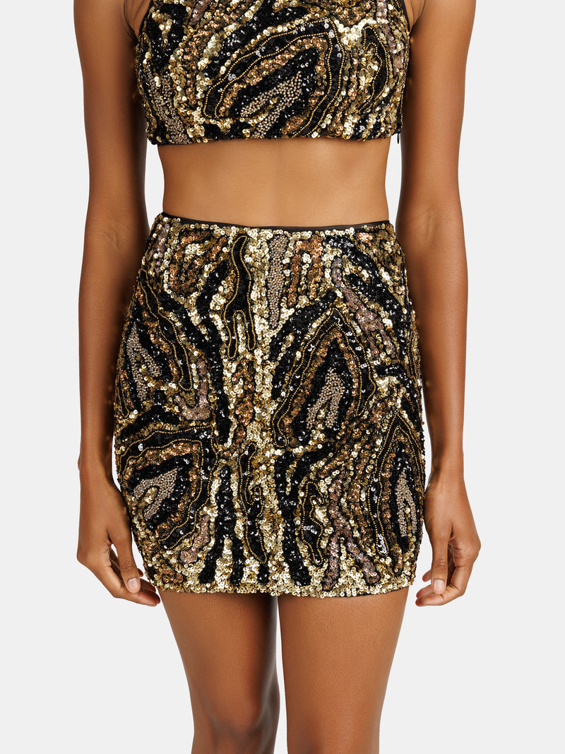 Abstract zebra pattern, sequin embellished mini skirt in gold and black tones designed by Maryane Claverol