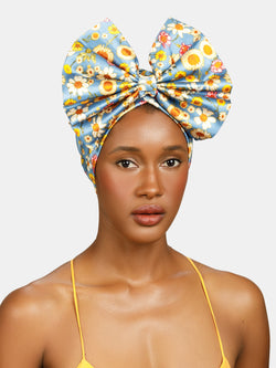 Daisy, Floral pinned turban with front bow designed by Maryjane Claverol