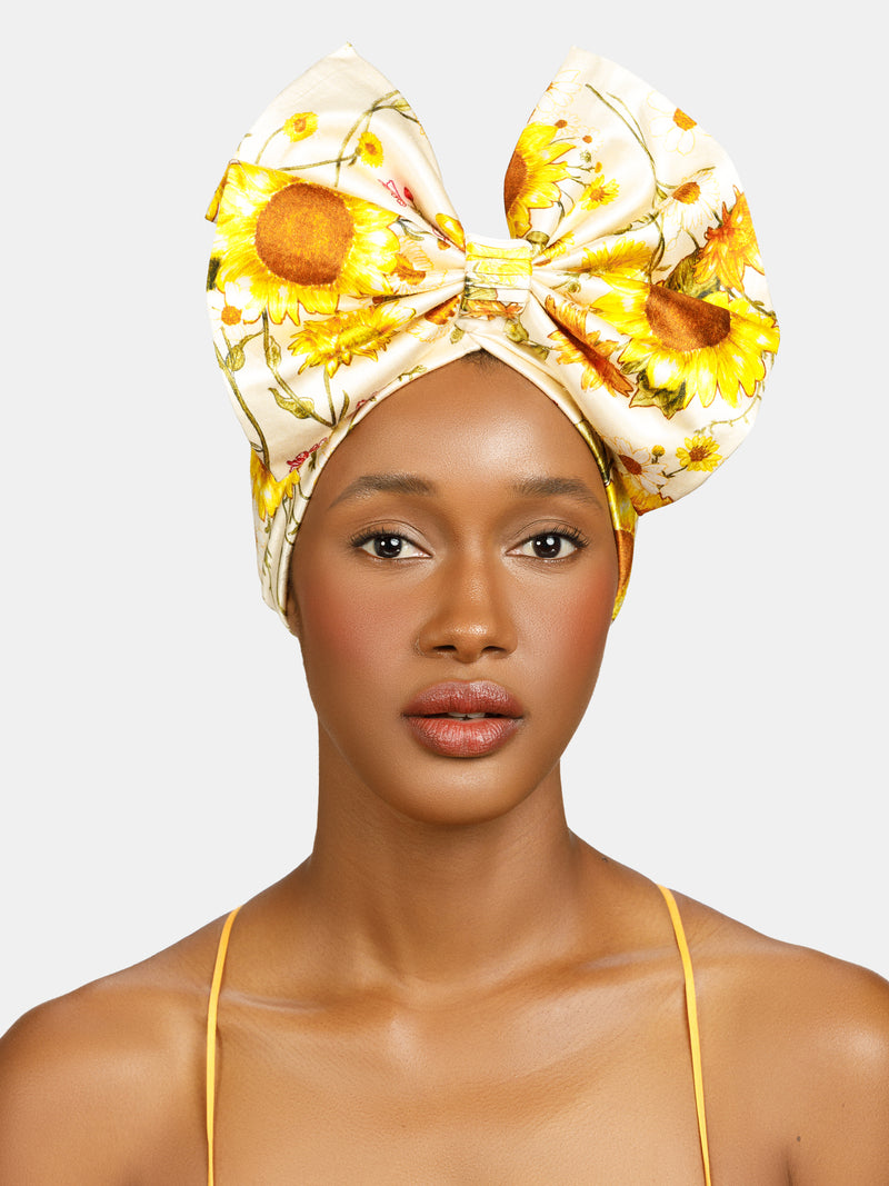 Sunflower, Floral pinned turban with front bow designed by Maryjane Claverol