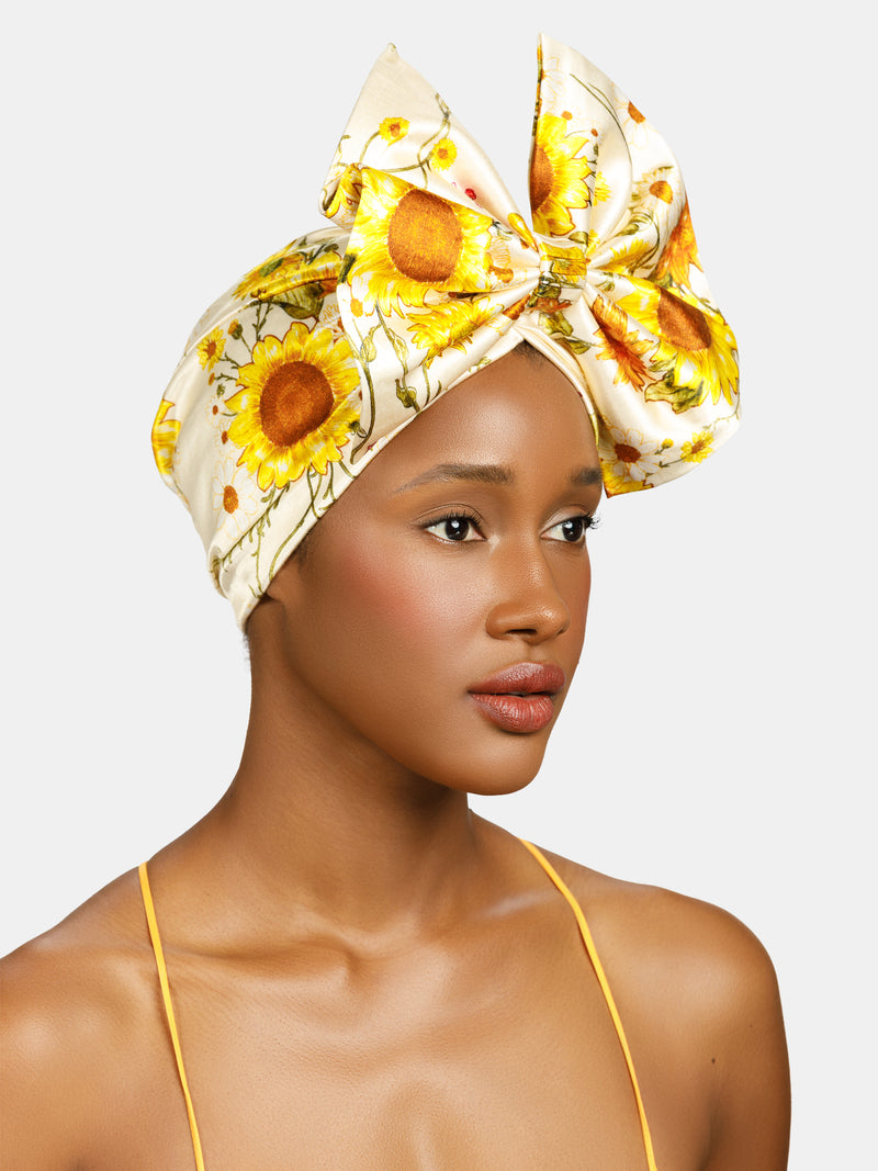 Sunflower, Floral pinned turban with front bow designed by Maryjane Claverol